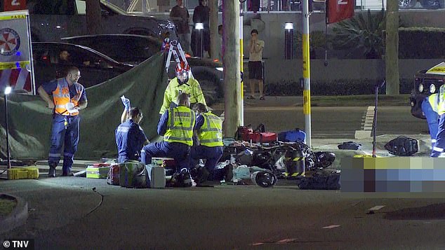 Paramedics try to treat one of the motorists at the scene