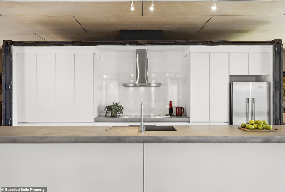 The kitchen is equipped with Miele appliances with a sandblasted stainless steel worktop and has underfloor heating