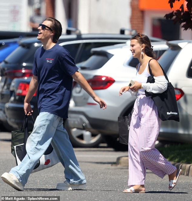 Jake couldn't wipe the smile off his face as he reached out to grab his wife Millie's hand, showing off her dazzling wedding ring, as they walked into a shopping centre.