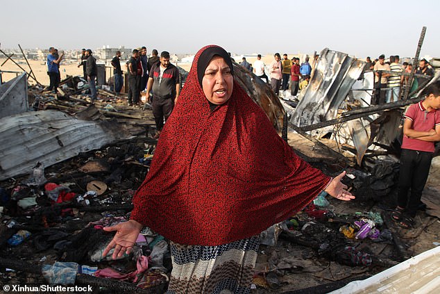 A person responds at the scene of an Israeli attack on a camp for displaced people in Rafah in the southern Gaza Strip, May 27, 2024