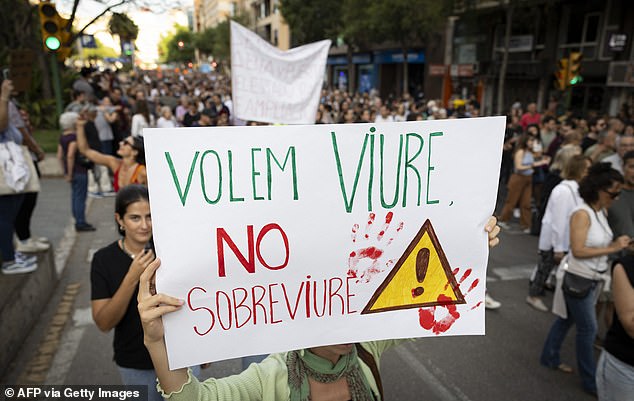 Protesters hold a sign 