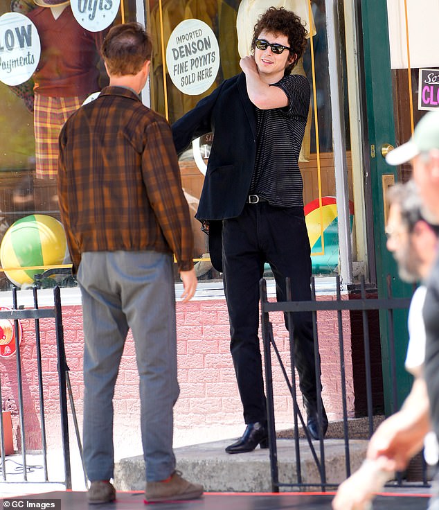 Norton wore a zip-up jacket over a plaid green shirt, and his look was completed with gray pants and tan shoes