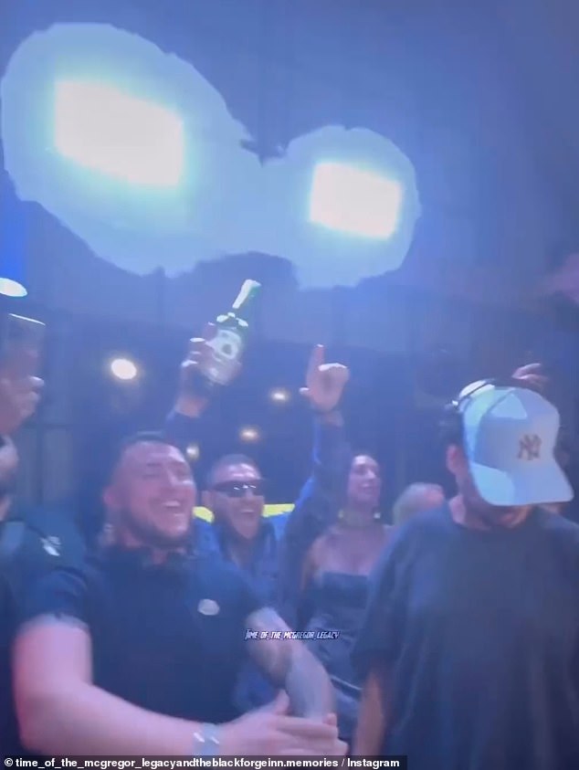 The Irish MMA fighter danced behind the DJ and raised a bottle of whiskey into the air