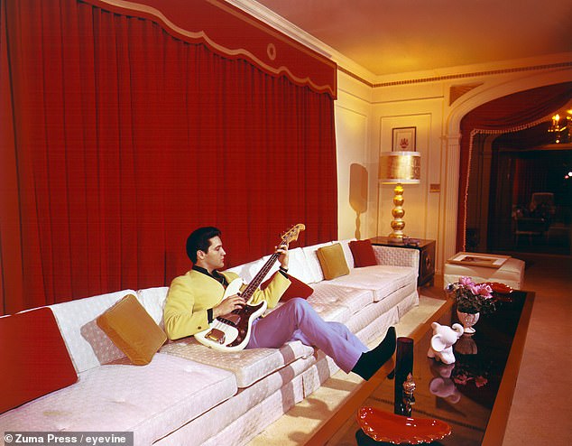 Elvis plays an electric bass at Graceland in this photo published March 7, 1965