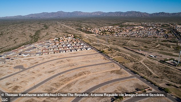 The development is taking place along the Sun Valley Parkway, about 40 miles west of Phoenix, which was once known as the 'Road to Nowhere' and for some who live there, it can still feel like a