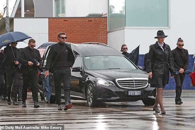 The pallbearers (pictured) wore tops with Cam McCarthy's initials embroidered on them