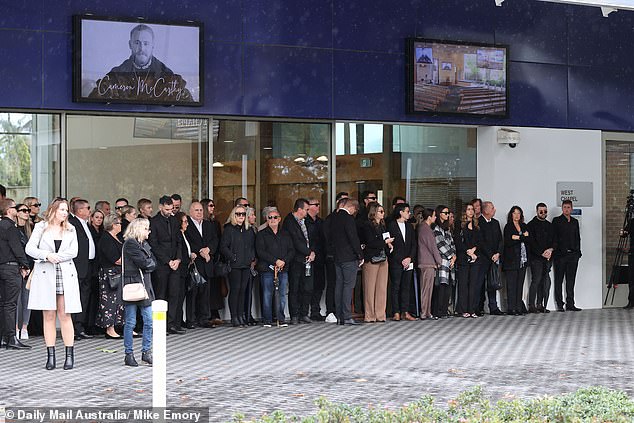 Funeral visitors are pictured outside the venue for McCarthy's farewell