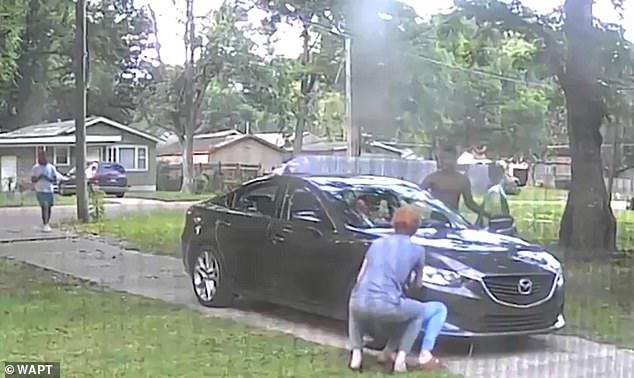 The shirtless man opens one of the back doors and pulls Allen's daughter out of the car as they demanded the keys