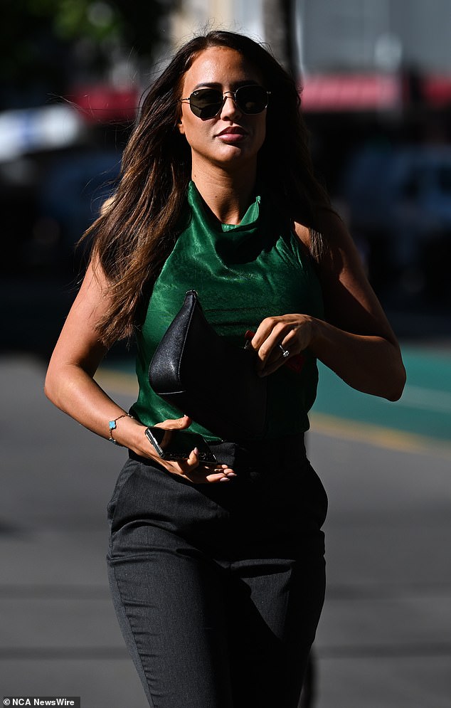 Kate wore a modest green satin halter top with black trousers, black patent pumps and a black leather handbag