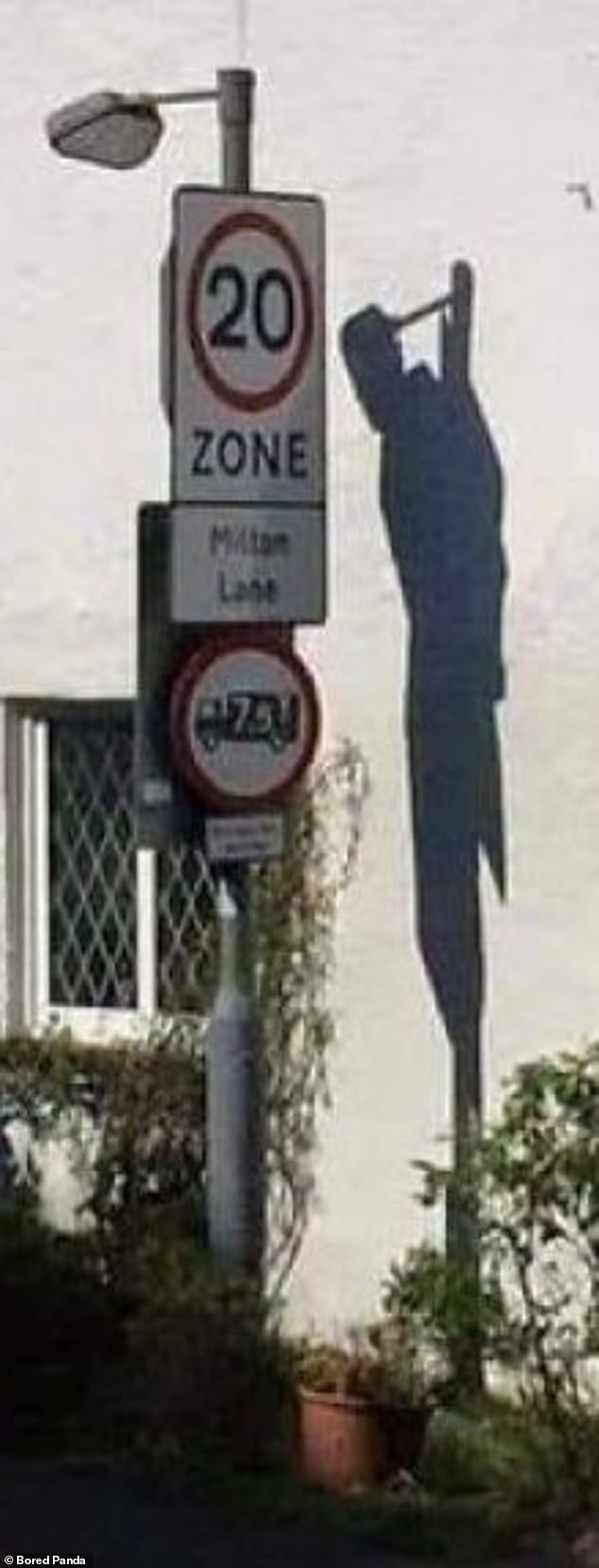 This sign, spotted on a street in Britain, isn't that threatening on its own, but the shadow certainly looks creepy