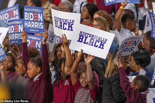 Students at Girard College, a K-12 boarding school with a predominantly black student body, hold up signs reading 