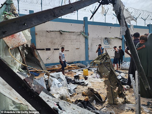 Palestinians examine destroyed makeshift tents after Israeli army attacks in Rafah, Gaza