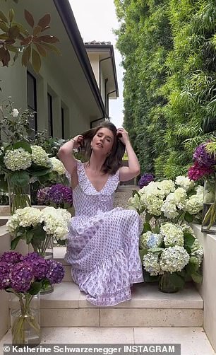 The influencer posed among the hydrangeas in a summer dress