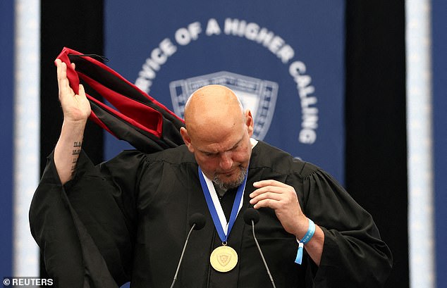 Fetterman (D-PA) removes a graduation cap from Harvard Kennedy School in protest of Harvard's treatment of the Jewish community on campus