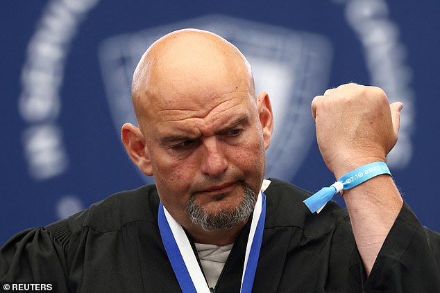 Fetterman (D-PA) shows a Nova Music Festival wristband given to him by a family member of someone taken hostage at the festival