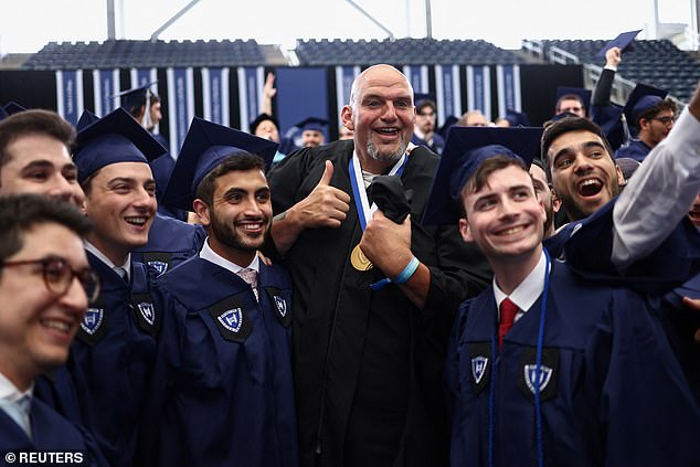 Fetterman poses with Yeshiva graduates who gave him a standing ovation for denying himself from Harvard