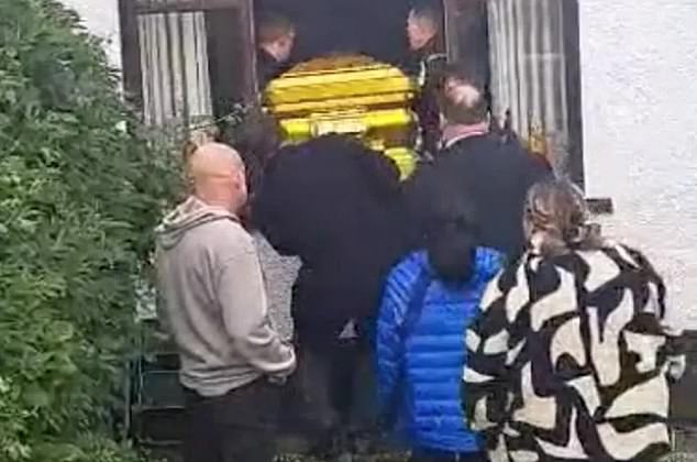 Photos show the lavish funeral of an Irish gangster who died in a car crash - complete with a gold-colored coffin and topless photos