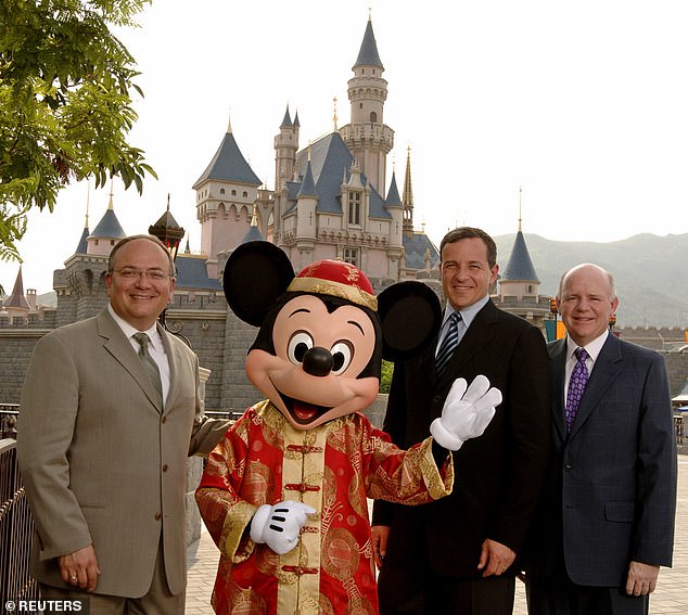 Jay Rasulo (left) with Mickey Mouse and Bob Iger (center right) in 2005. The former CFO spent 30 years at the company.  Iger recently revealed that the company will 'quiet the noise around cultural issues' as it has proven to be bad for business