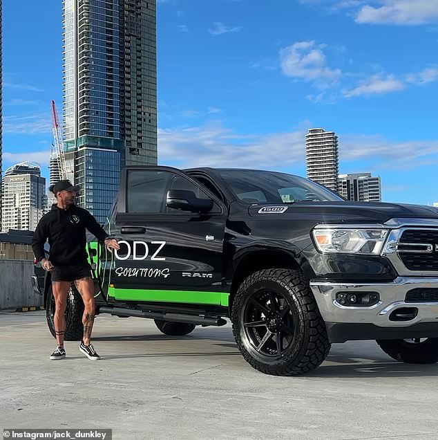 The Gold Coast star was seen smiling as he posed next to a custom black ute with custom stickers labeled 'ALLBODZ' printed on it