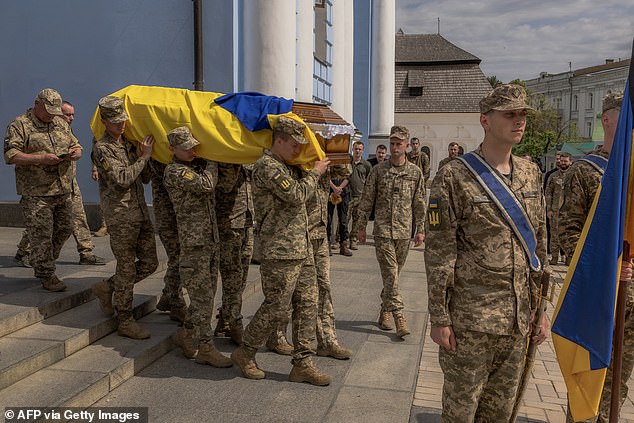 Ukrainian soldiers carry the coffin of a Ukrainian soldier who died in the Donetsk region