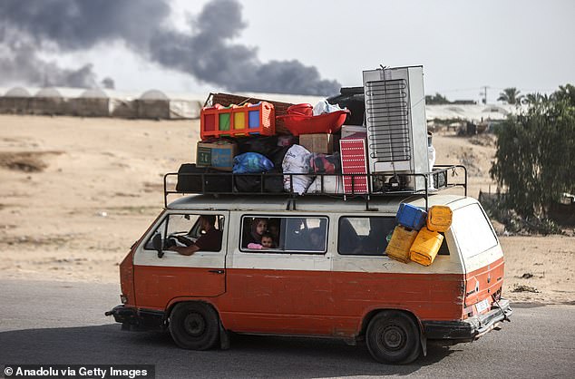 Palestinians are migrating, carrying their personal belongings, to areas they consider safe after the Israeli army attacked tents in Al-Mawasi, previously declared a 'safe zone' by Israel, in the city of Rafah in southern Gaza