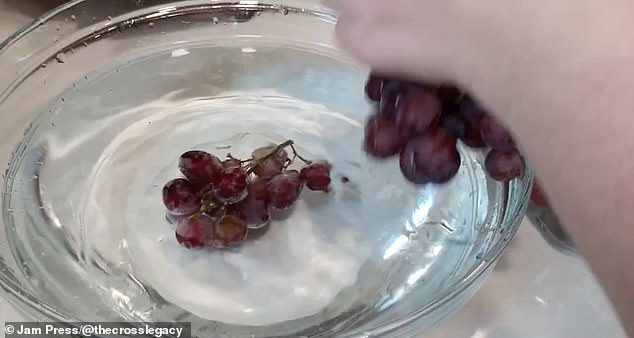 Berries and grapes are soaked in water and vinegar and shaken so that all sides are clean