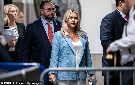 Trump campaign press secretary Karoline Leavitt (C) and Trump adviser Jason Miller (L) arrive at the criminal trial of former US president and Republican presidential candidate Donald Trump in the Manhattan Criminal Court criminal trial in New York City on May 29, 2024. Jurors in Trump's hush money trial begins today with deliberations on whether to overturn the first criminal conviction of a former president — a momentous decision that could upset November's presidential election.  (Photo by Doug Mills / POOL / AFP) (Photo by DOUG MILLS/POOL/AFP via Getty Images)