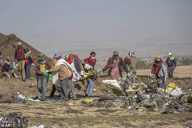 Rescuers work at the scene of an Ethiopia Airlines flight from a Boeing 737 Max 8 plane crash near Bishoftu, or Debre Zeit, south of Addis Ababa, Ethiopia, on March 11, 2019, that killed 157 people