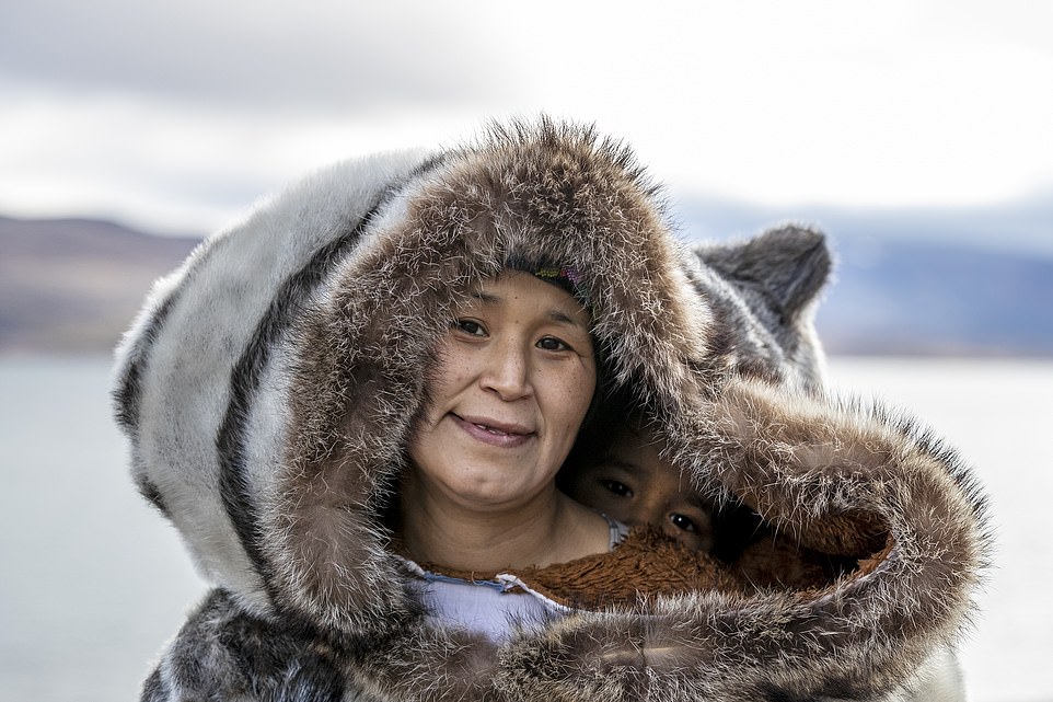 CANADIAN ARCTIC - Molly (pictured) and her shy daughter wear traditional Inuit clothing known as amautis, made from seal skins