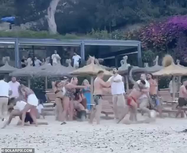 People were pushed and shoved on a beach in Mallorca on Wednesday after a fight broke out between British tourists and restaurant staff.  The tourists, who were on a stag party, were seen throwing cans of beer into the sea.  The fight broke out after the waiter told him to stop.