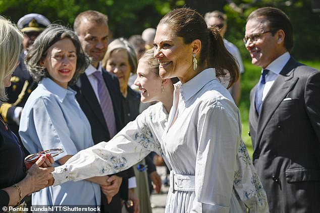 Smiling, Victoria greeted well-wishers as her confident daughter showed off her official royal duties as she shook hands