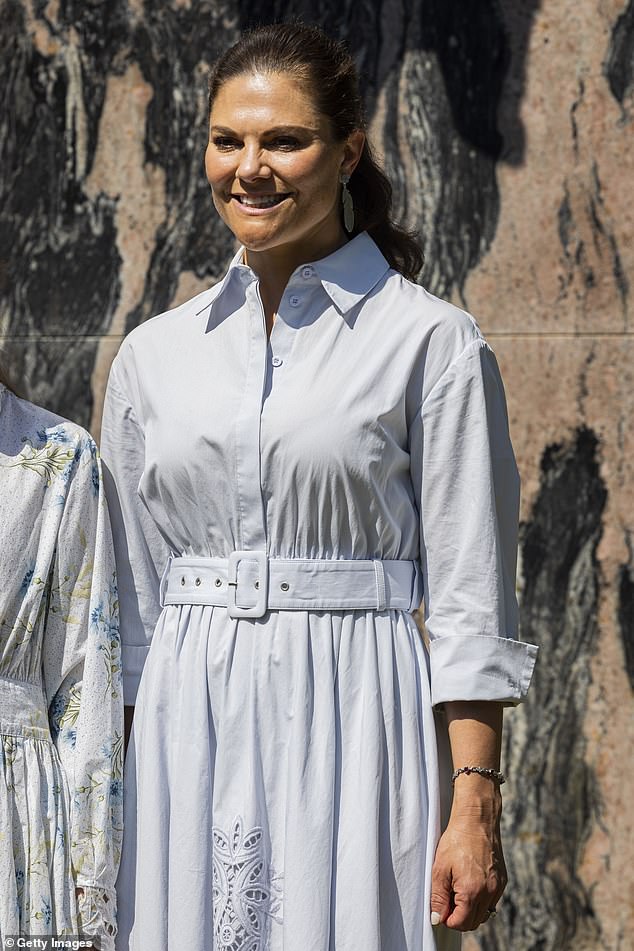 Victoria's dress (pictured) was cinched at the waist with a chic white belt and her longer dress was finished with a patterned hem