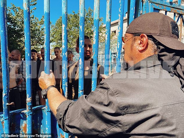 Seagal speaks to Ukrainian prisoners through metal bars.  Seagal vocally supported Russia's 2014 annexation of Crimea