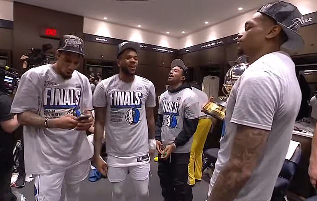 Dallas Mavericks players celebrate in the locker room after reaching the NBA Finals