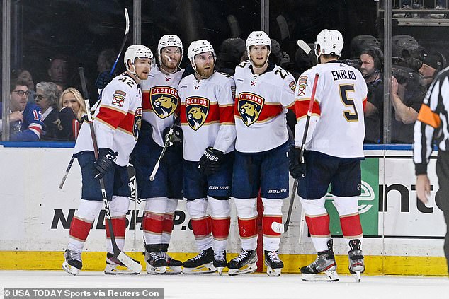 The Panthers celebrate an empty-net goal by Sam Bennett (center) in the third period