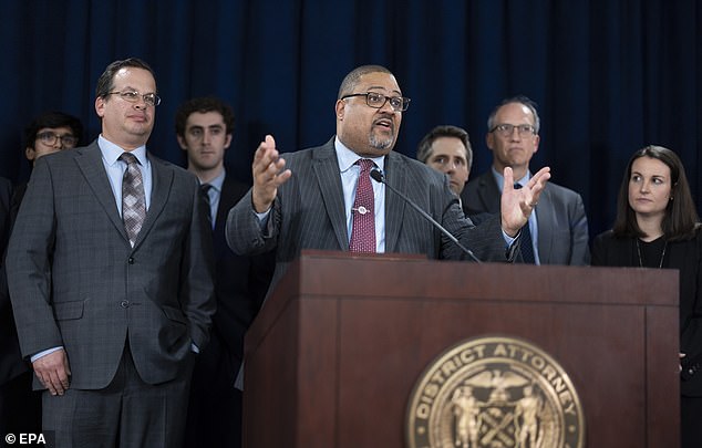 Manhattan District Attorney Alvin Bragg (center) speaks with prosecutor Joshua Steinglass (left) next to him at a triumphant post-verdict press conference