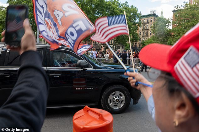 Supporters of former US President Donald Trump cheer as his motorcade leaves Manhattan Criminal Court after he was found guilty in his hush money trial on May 30, 2024