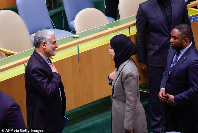 Iranian Ambassador to the United Nations Saeed Iravani (L) receives condolences during a United Nations (UN) General Assembly tribute to the late Iranian leader