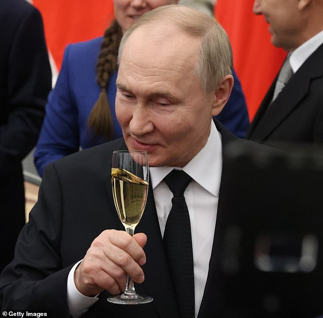 Russian President Vladimir Putin (C) toasts during an awards ceremony at the Kremlin on May 30, 2024 in Moscow