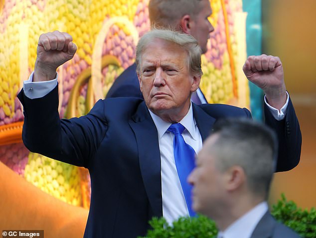 Donald Trump raises his fists in the air as he returns to Trump Tower on Thursday evening