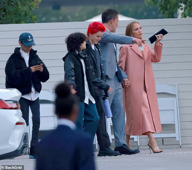 The singer carried a chic black clutch for the graduation festivities