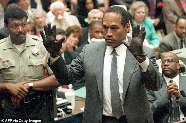 Simpson shows the jury a new pair of oversized Aris gloves, similar to those found at the LA crime scene during his double murder trial, which has sparked controversy