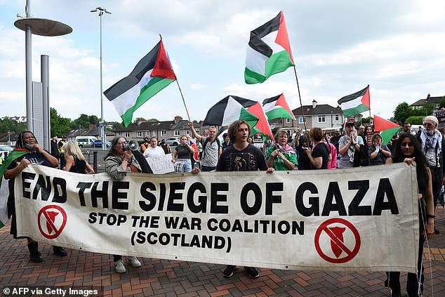 Pro-Palestinian supporters waved Palestinian flags outside the ground before the match