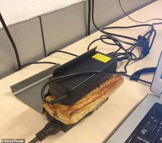 An office worker strangely demonstrated how to double up laptop chargers as food warmers