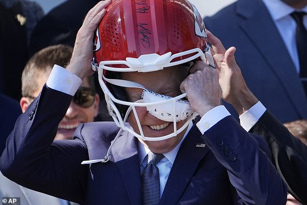 President Joe Biden stuck his head in a Kansas City Chiefs helmet during the team's Super Bowl event on the South Lawn