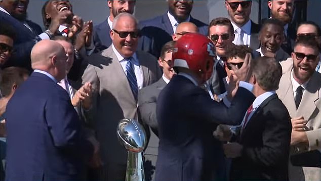 Butker could even be seen smiling after the president donned a Chiefs helmet on Friday