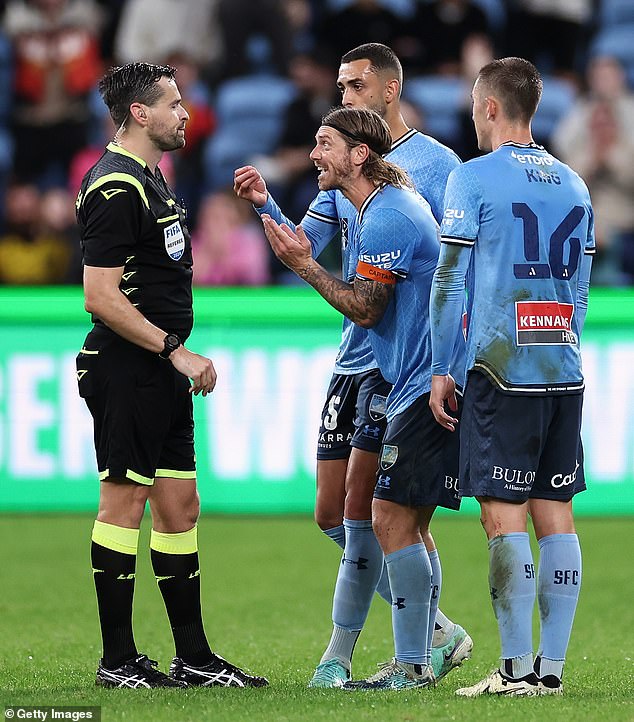 Sydney FC captain Luke Brattan (pictured centre) has claimed he was punched by Central Coast Mariners striker Alou Kuol during an ill-tempered first leg of the A-League Men's semi-final on Friday