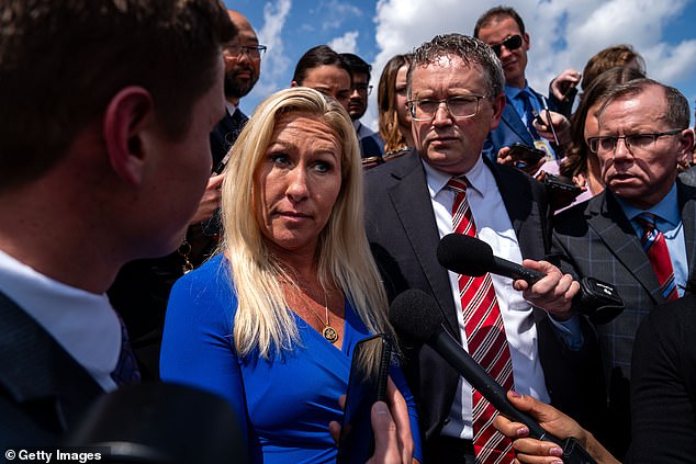 Reps. Marjorie Taylor Greene, left, and Thomas Massie, second from right, have laid out a list of demands for Speaker Mike Johnson — and are now holding back their move to impeach him.