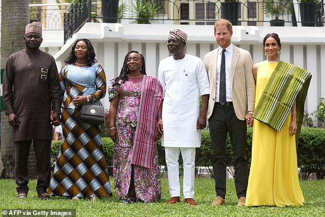Harry pictured in Lagos this month with his wife Meghan Markle (far right) and Nigerian Chief of Defense Staff Christopher Musa (far left), his wife Lilian Musa (second from left), Lagos State Governor Babajide Sanwo-Olu (third from right) and his wife, Ibijoke Sanwo-Olu (third from left)