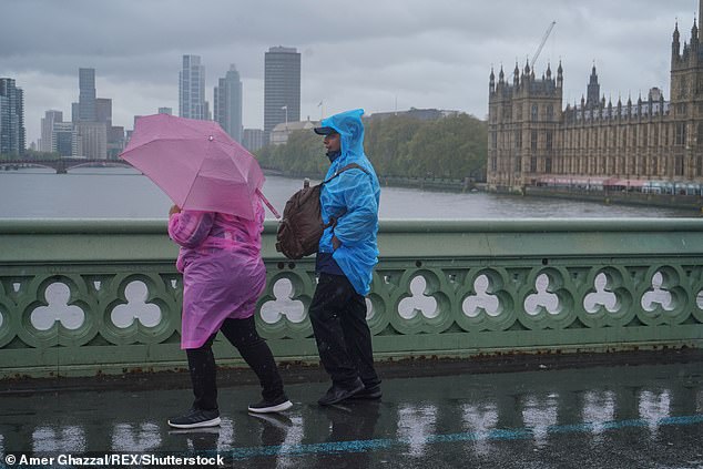 In news that will come as no surprise to most Britons, the Met Office has confirmed that April was the sixth wettest since records go back to 1836. Pictured: Pedestrians on Westminster Bridge on April 19